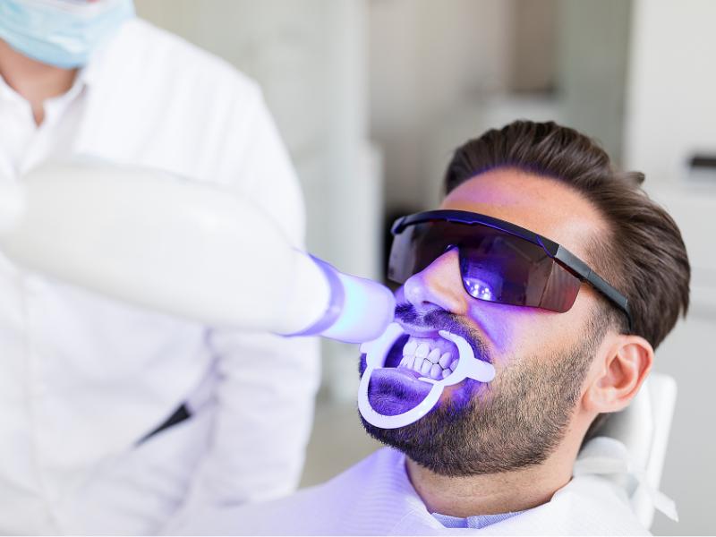 A patient undergoing in-office professional teeth whitening in Rockwall, TX
