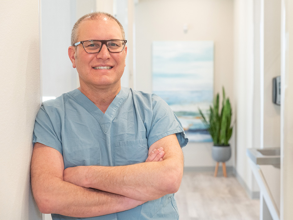 Rockwall dentist, Dr. Jeffrey Minth, warmly smiling, radiating professionalism and friendliness at his dental office, The Right Dentist.
